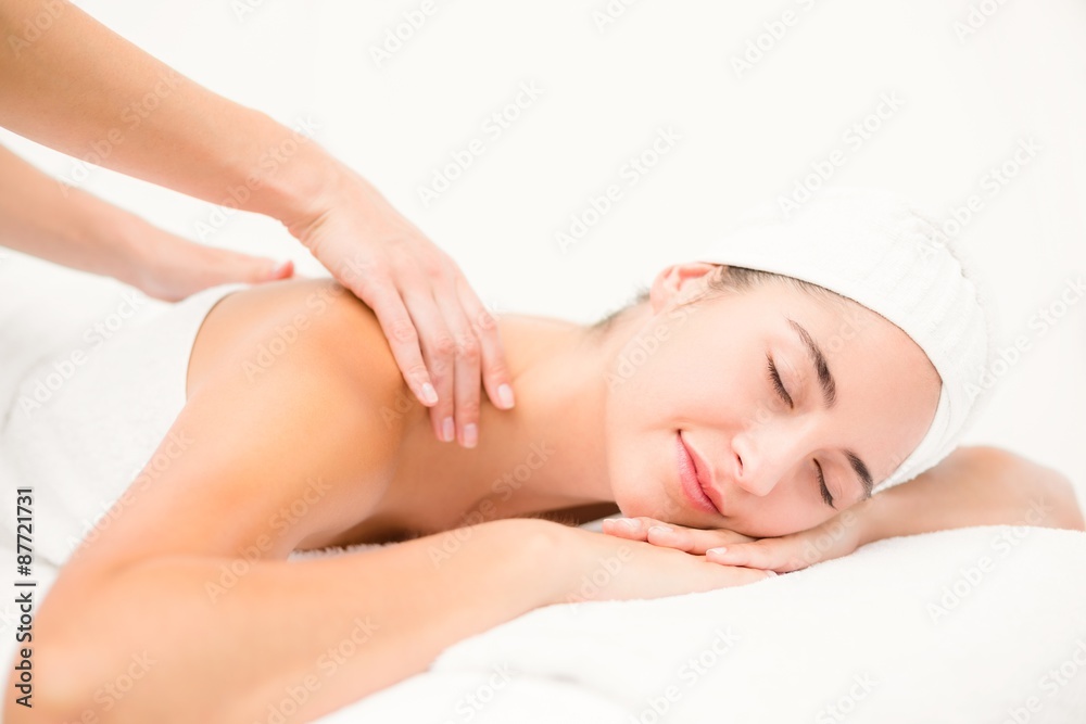 Attractive young woman receiving shoulder massage