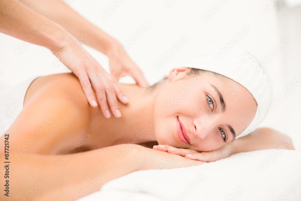 Attractive young woman receiving shoulder massage Attractive young woman receiving shoulder massage