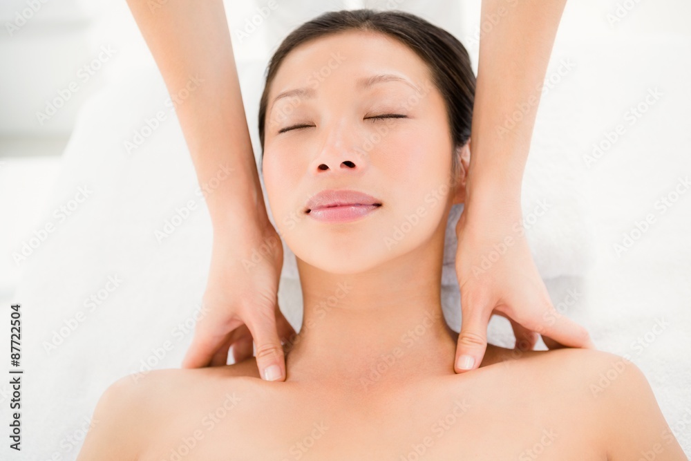 Attractive young woman receiving shoulder massage