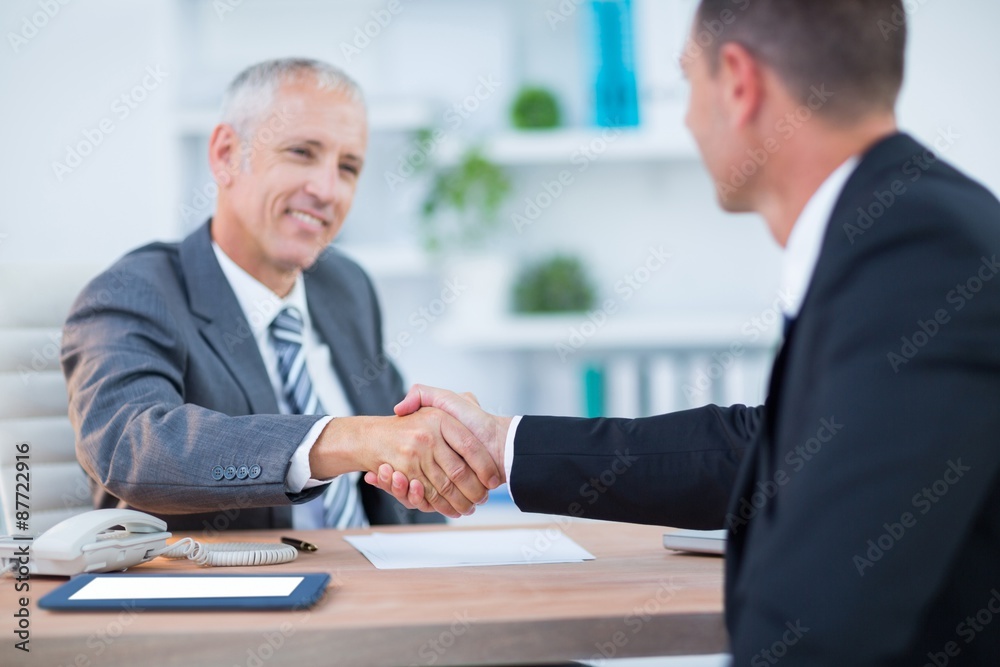 Happy businessmen shaking hands Happy businessmen shaking hands
