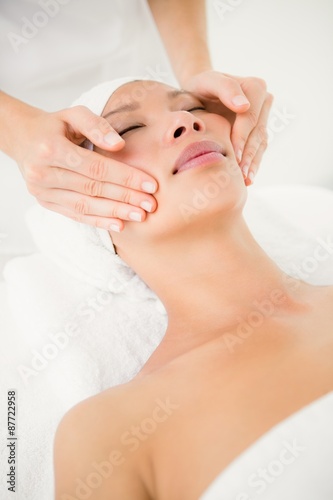 Attractive woman receiving facial massage