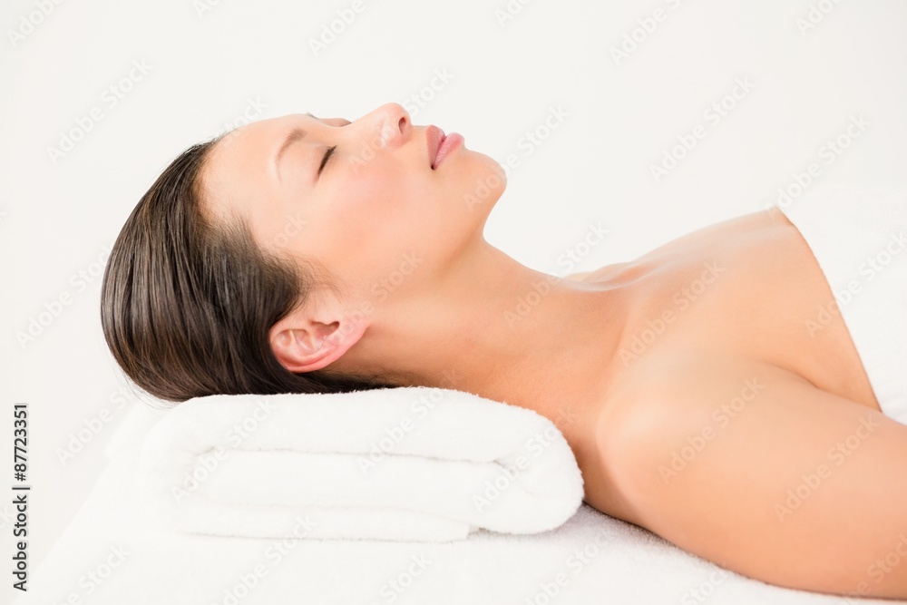 Woman lying on massage table at spa