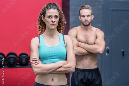 Serious muscular couple looking at the camera