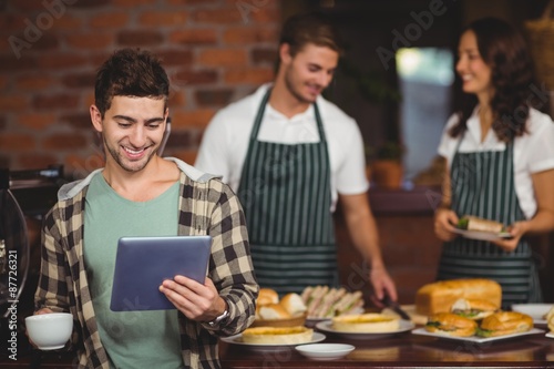 Smiling customer looking at tablet