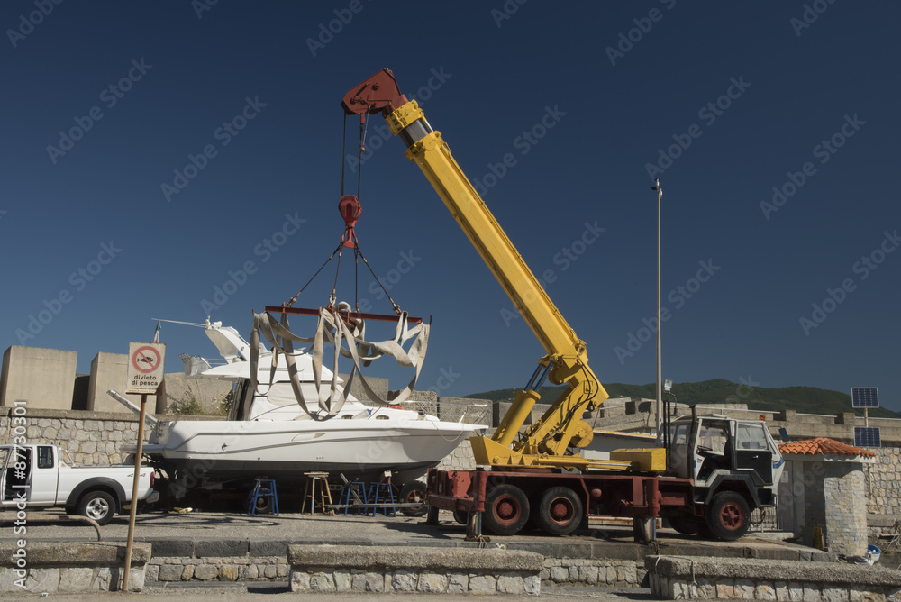 Cranes at the Port. Splashdown boat with crane and belts. Port of Palinuro. Cilento. Italy.

