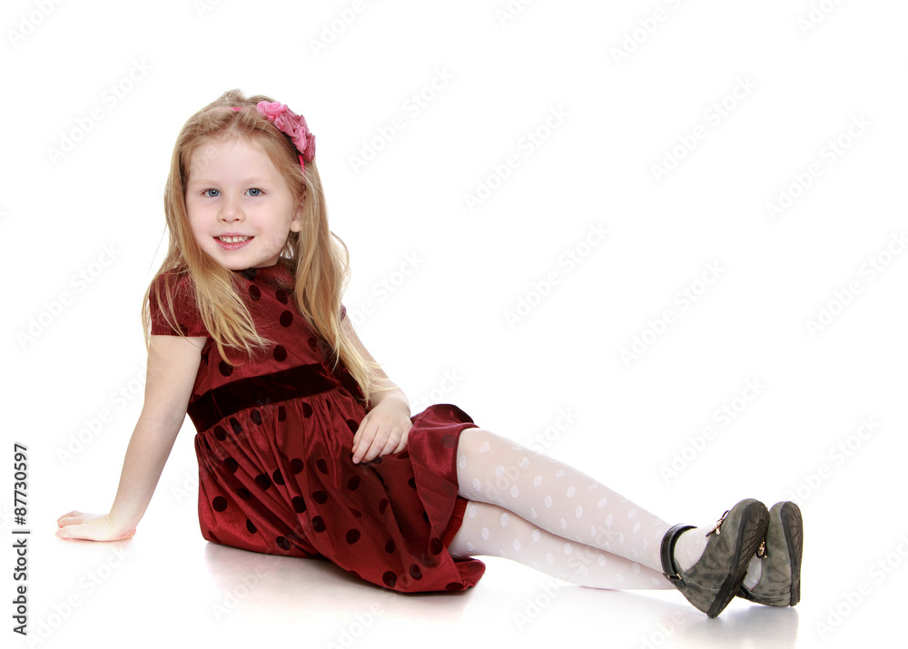 Adorable little girl sitting on the floor Adorable little girl sitting on the floor