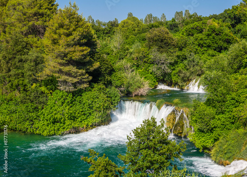 Krka waterfalls in the forest on a sunny day.
