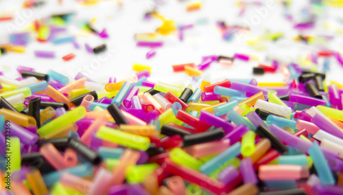 Colorful confetti on white background, closeup
