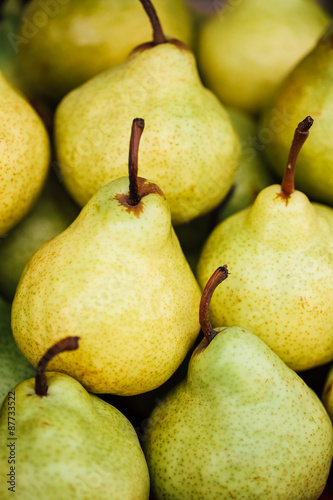 Green and yellow ripe pears background