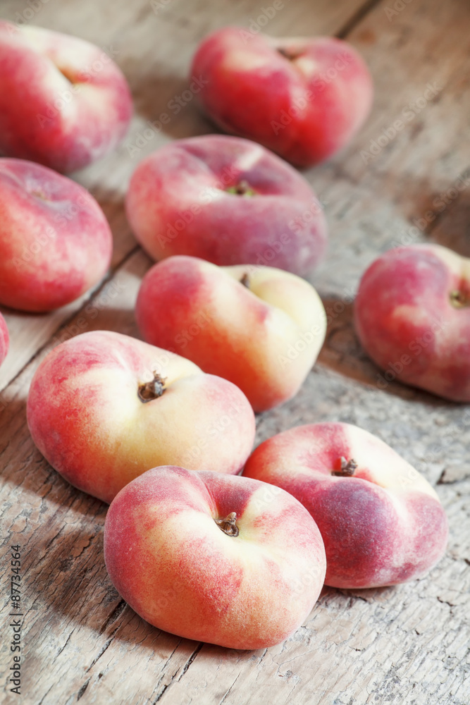 Flat pink peach on an old wooden background, selective focus Flat pink peach on an old wooden background, selective focus