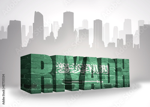 text riyadh with national flag of saudi arabia near abstract silhouette of the city
