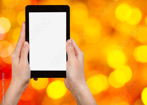 hand with tablet pc on blurred xmas background
