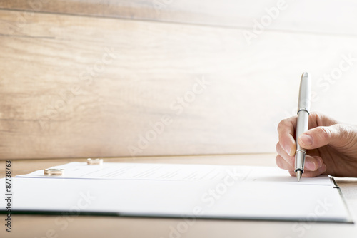 Signing marriage contract or divorce papers photo