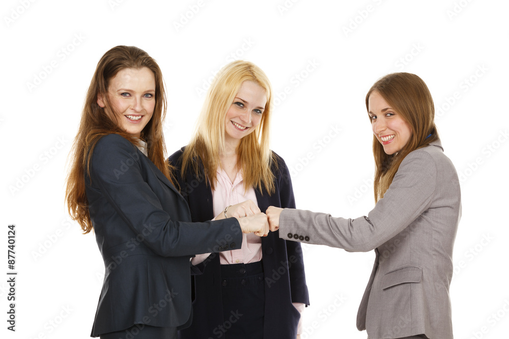 Three businesswomen putting their fists together in a 