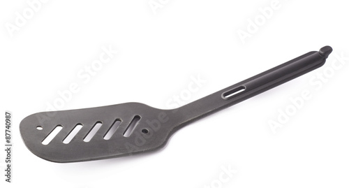 Used black plastic spatula isolated