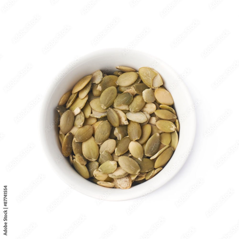 White cup filled with pumpkin seeds White cup filled with pumpkin seeds