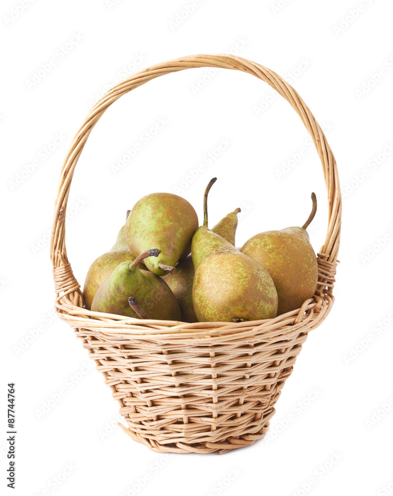 Wicker basket filled with pears isolated