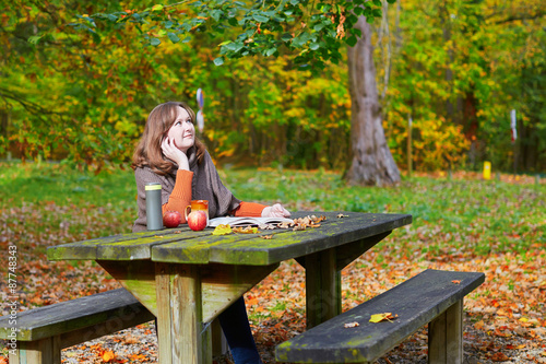 Quadro em tela Girl having a picnic in park on a fall day
