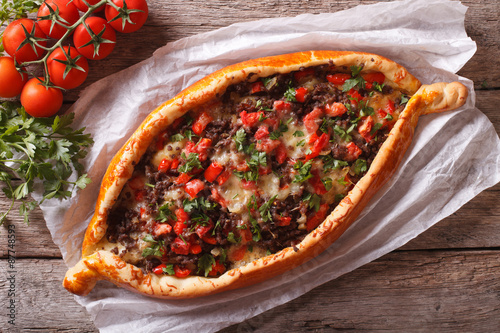 Turkish pide pizza with meat closeup. horizontal view from above
 photo