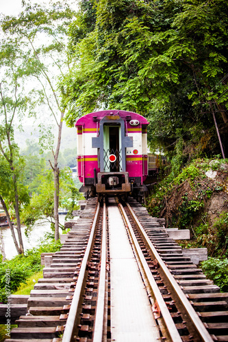 Trains run on tracks through the woods and cliffs 