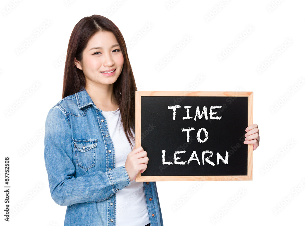 Woman with chalkboard showing phrase of time to learn Woman with chalkboard showing phrase of time to learn