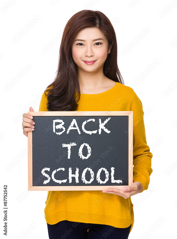 Woman with chalkboard showing phrase of back to school Woman with chalkboard showing phrase of back to school