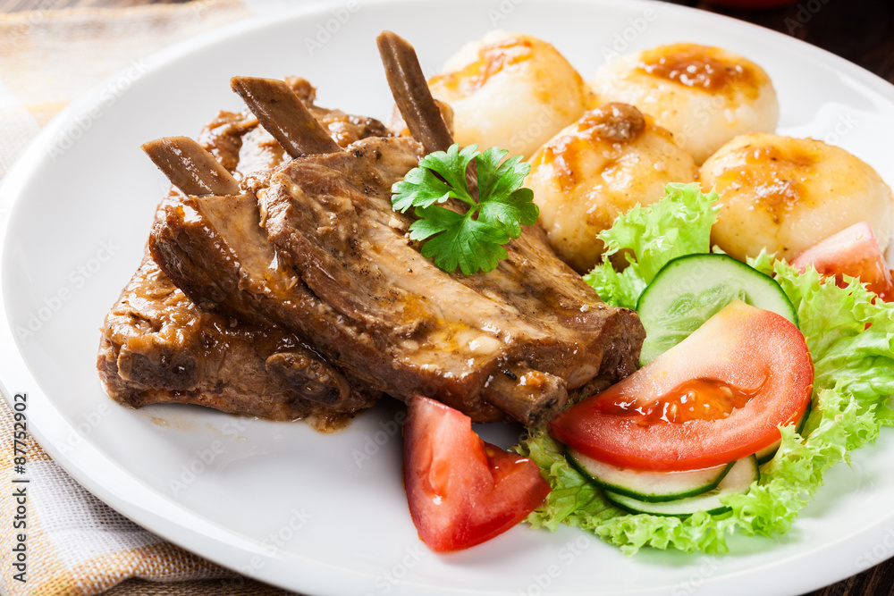 Pork spareribs served with silesian noodles and sauce Pork spareribs served with silesian noodles and sauce