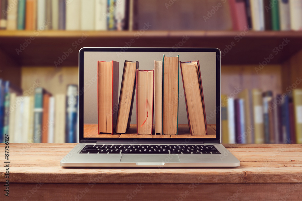 Fototapeta premium E-book library concept with laptop computer and books