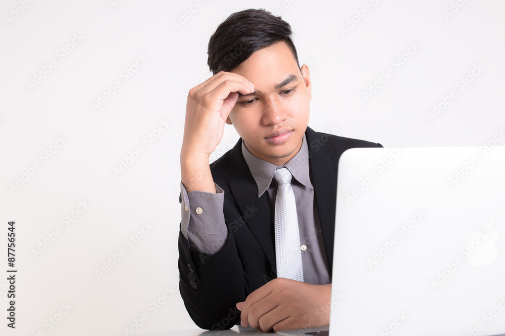 Businessman working on a laptop. isolated over a white backgroun Businessman working on a laptop. isolated over a white backgroun