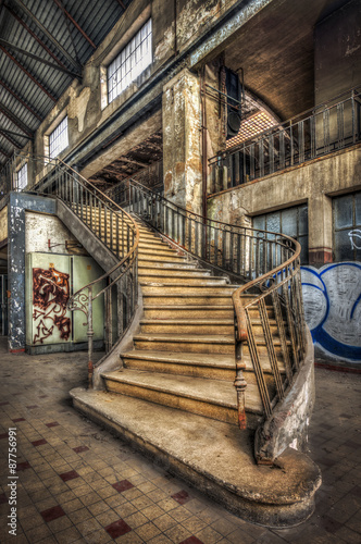 Imposing staircase inside the hall of an abandoned power plant