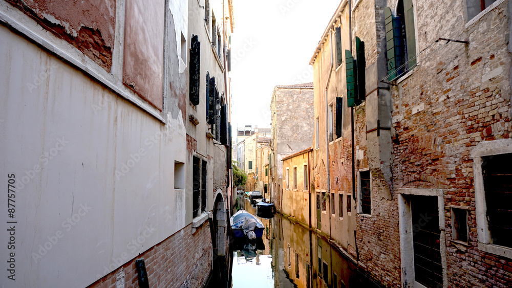 Alley and canal with ancient architecture