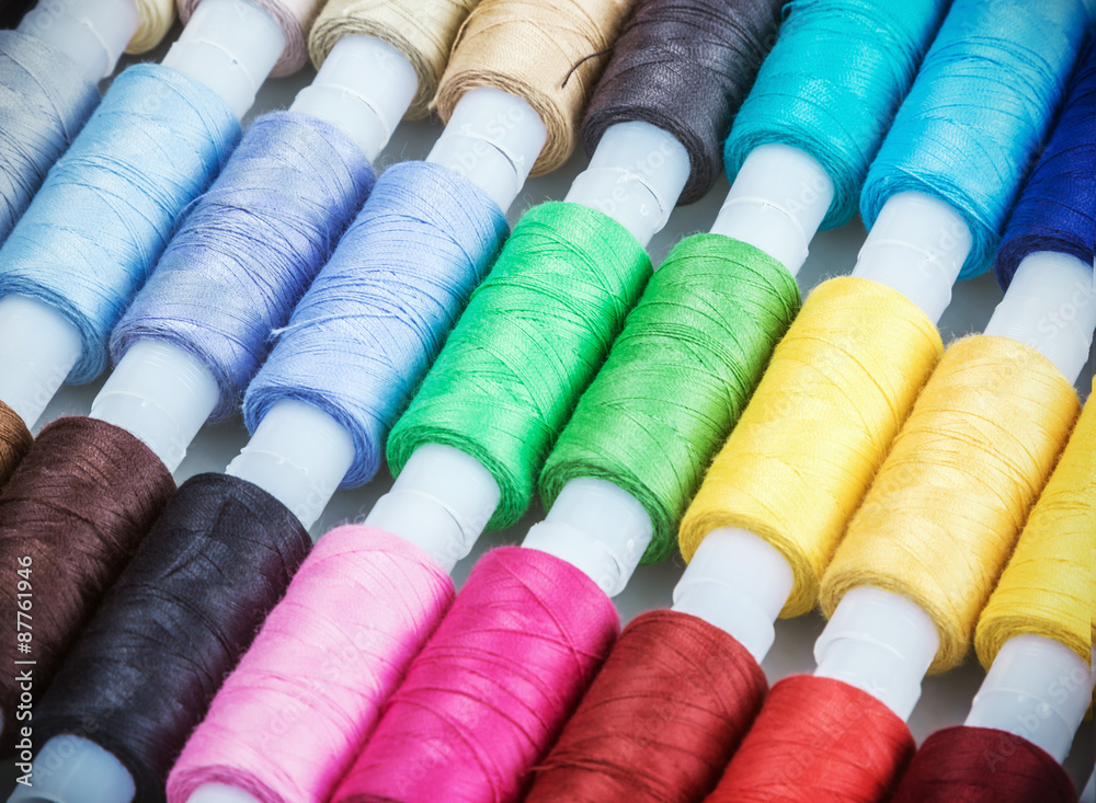 Multicolor sewing threads on background Multicolor sewing threads on background