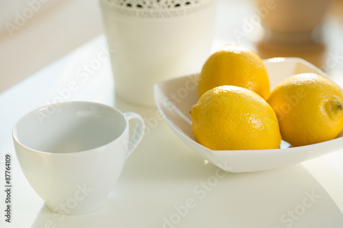 Close up of cup and lemons