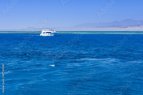 white boat in red sea © Nataly-Nete