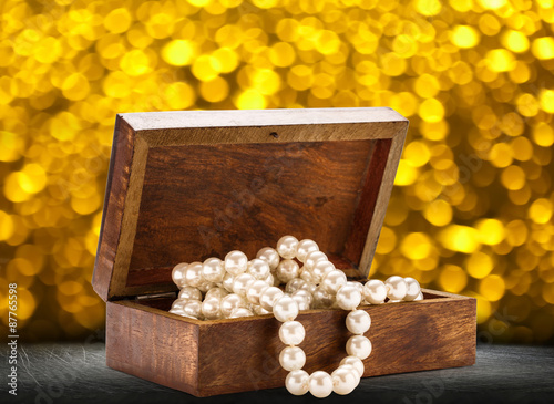 Wooden chest with white pearl necklace