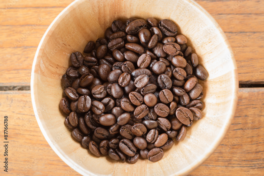 Fototapeta premium Roasted coffee beans in wooden bowl