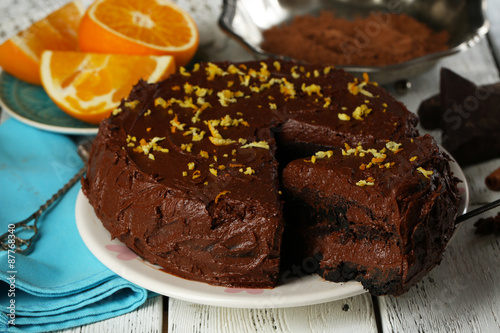 Chocolate cake with oranges on table, close-up