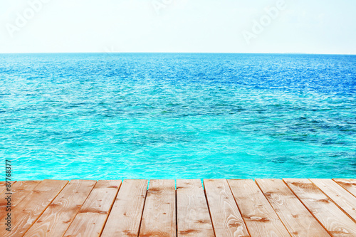 Wooden pier with blue sea background