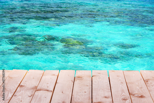 Wooden pier with blue sea background