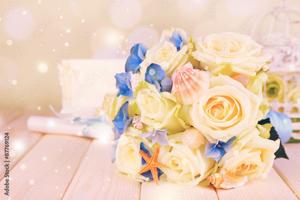 Beautiful wedding bouquet with sea decor on wooden table Beautiful wedding bouquet with sea decor on wooden table