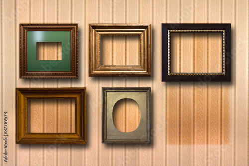 Gilded wooden frames for pictures on background