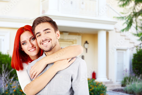 Loving couple near their house