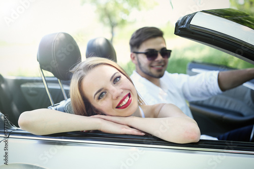 Young couple in cabriolet, outdoors © Africa Studio