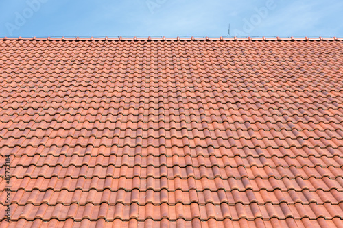 Red tiles roof background and blue sky