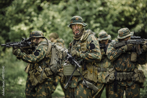 Group of soldiers special forces during the raid in the forest