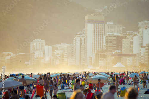 Busy crowded afternoon on Ipanema Beach during a misty sunrise in Rio de Janeiro Brazil