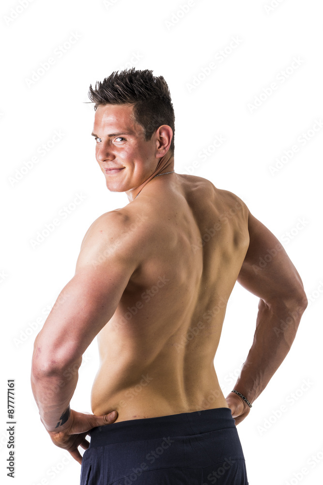 Fototapeta premium Back of topless muscular man standing, studio shot