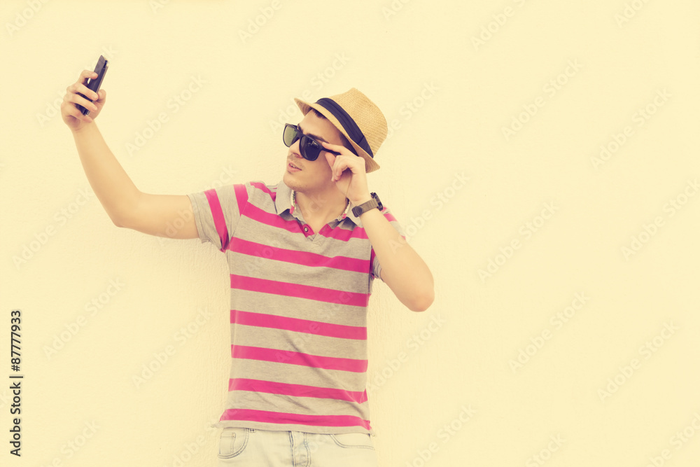 Urban guy taking a selfie outdoors. Urban guy taking a selfie outdoors.