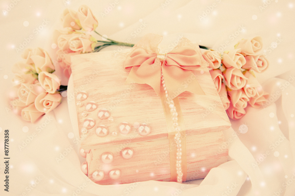 Beautiful hand made casket and flowers on light cloth background Beautiful hand made casket and flowers on light cloth background