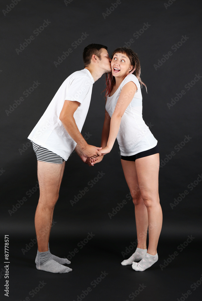 Funny young couple on black background Funny young couple on black background
